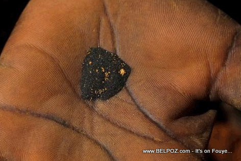 Metal Mining in Haiti - A woman's hand filled with gold deposits