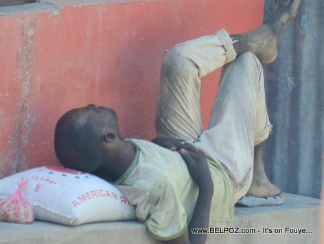 PHOTO: Haitian man taking a nap with a bag of rice under his head